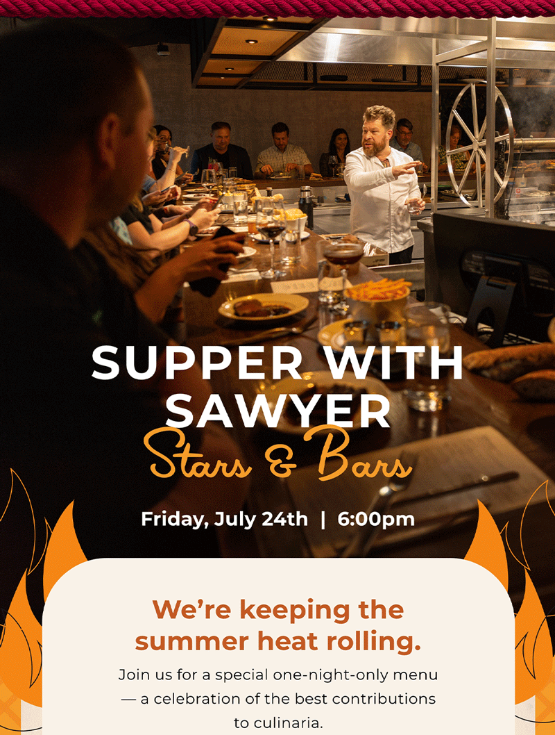 A thick, highly marbled raw cut of premium beef resting on a wooden cutting board, highlighting the exceptional ingredients featured at Kindling Chicago's upcoming Supper with Sawyer weekend dining event.